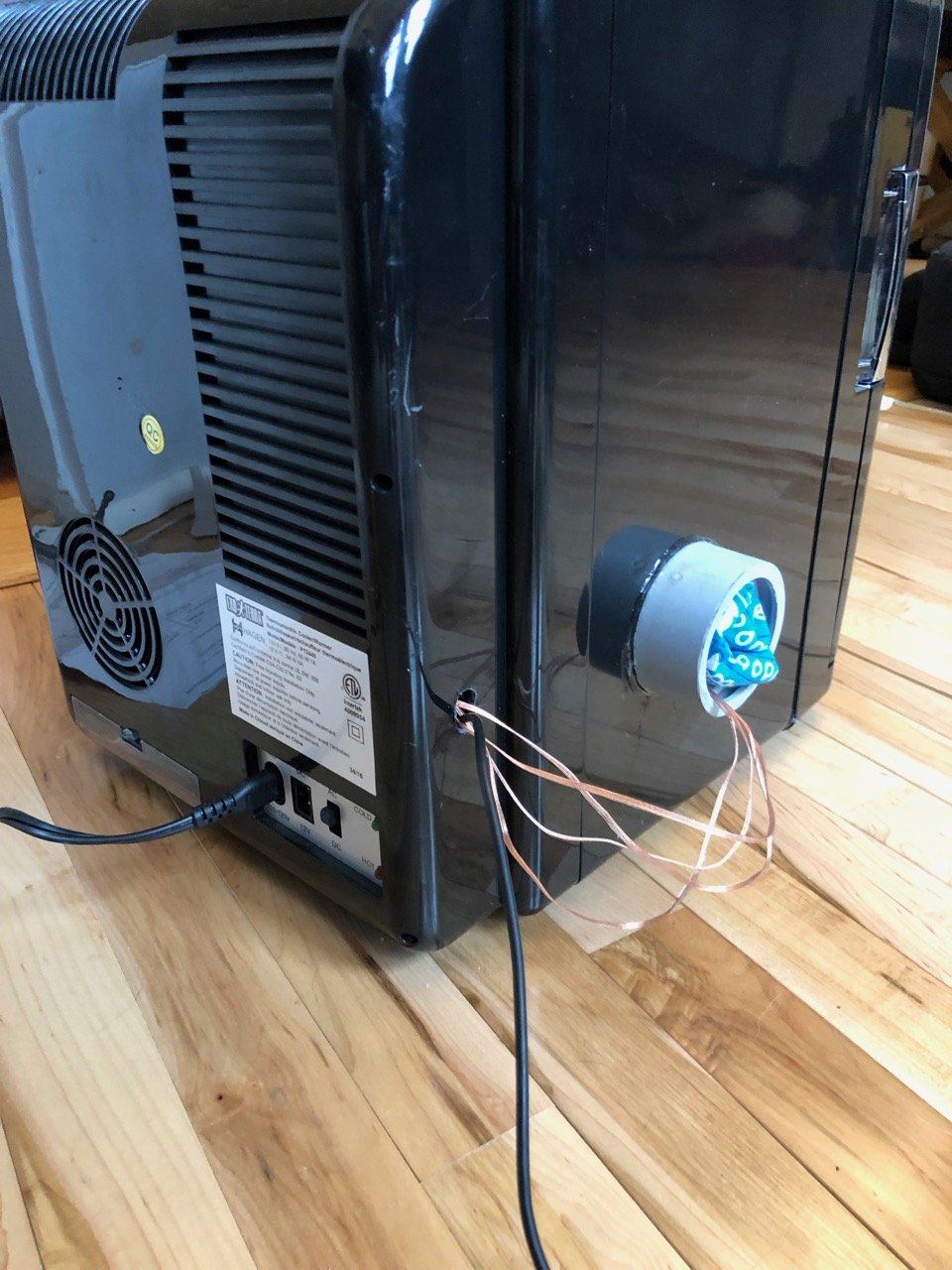 Cables run thru a small hole in the rear cover