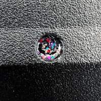 Photo of a screw covered with a unique pattern of (multi-color) glitter nail polish