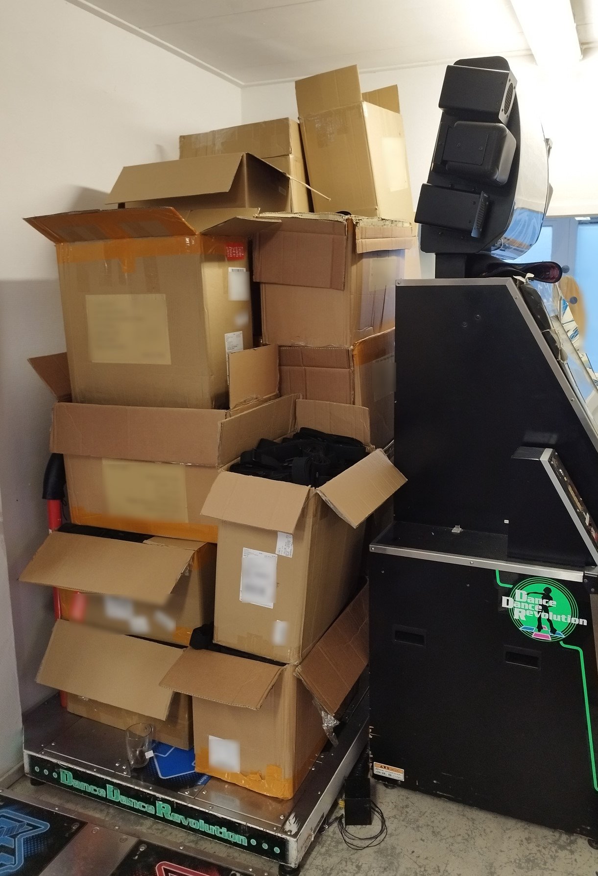 All of these boxes are full of bundles of straps. 5000 bundles total. DDR arcade machine and a tea cup for scale :)