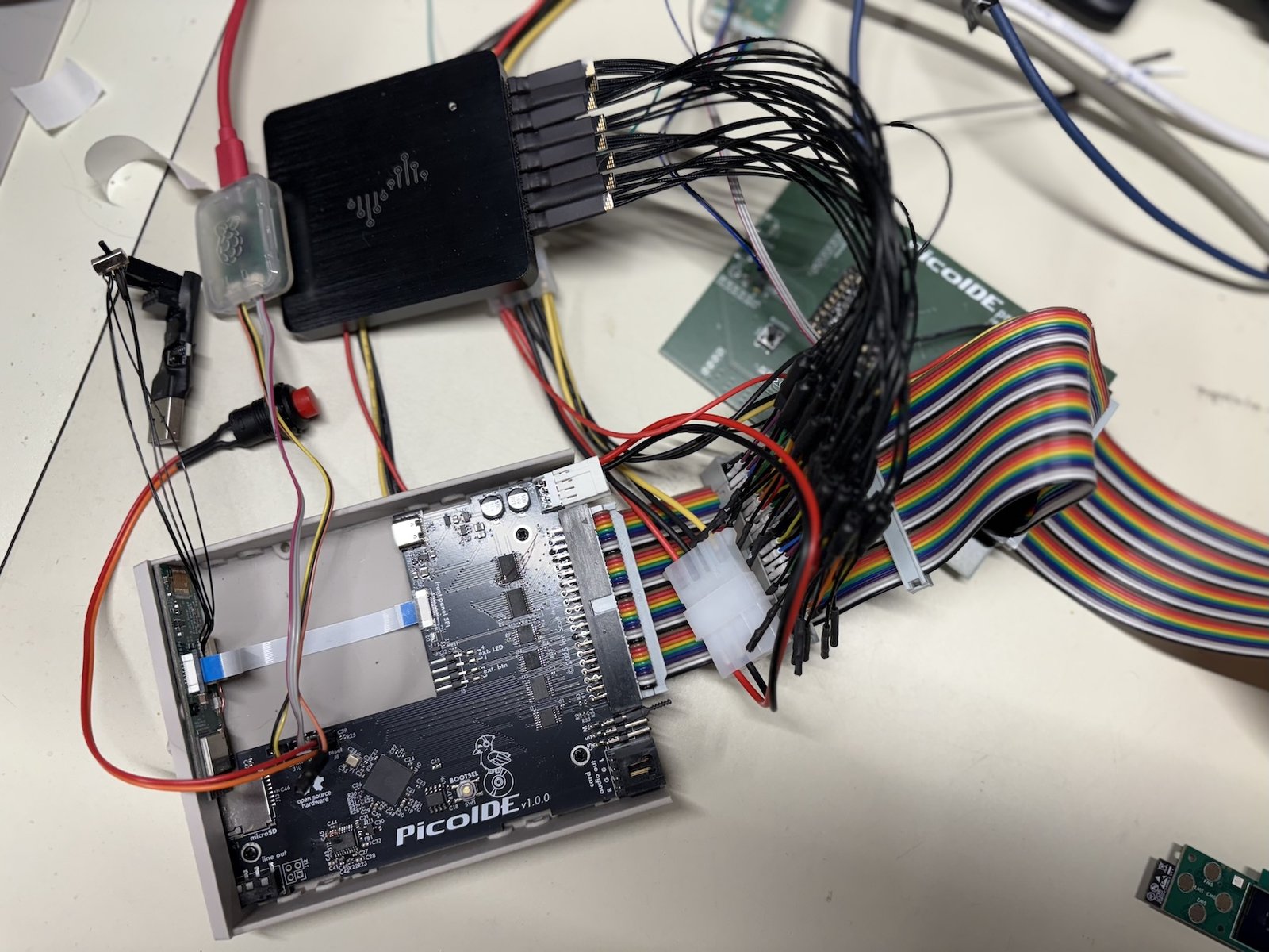 Ribbon cable connecting PicoIDE and enclosure, logic analyzer and probe wires, and prototype PicoIDE board