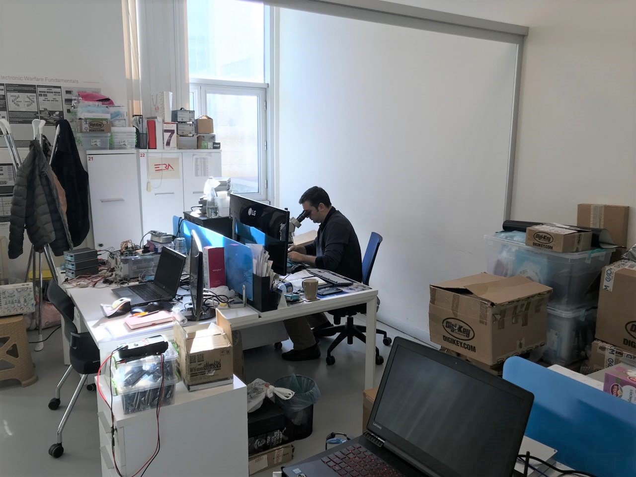 Erkin working under the microscope.