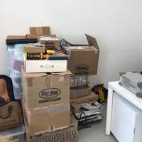 Adnan surrounded by Digikey boxes.