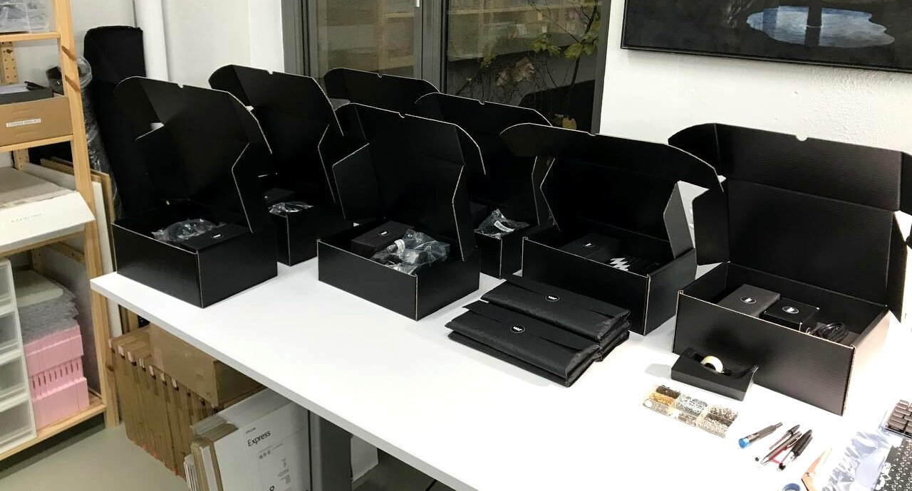 A number of MNT Reform boxes on a table, being prepared for shipment