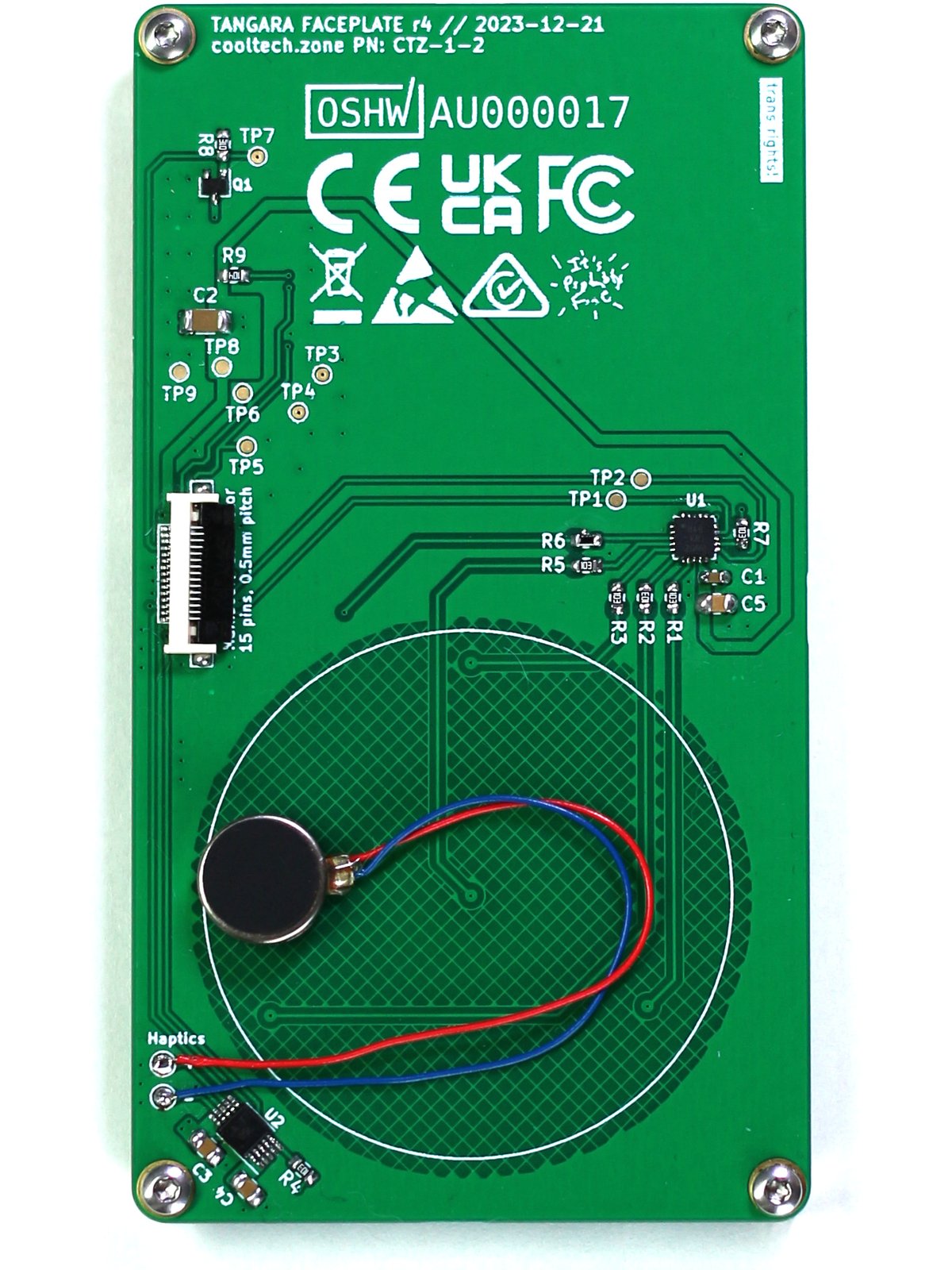 The reverse side of the same rectangular portrait-orientation PCB. There is a ZIF connector to connect to the main board, a small cylindrical haptic motor attached over the back of the touchwheel area, and some assorted components and test points.